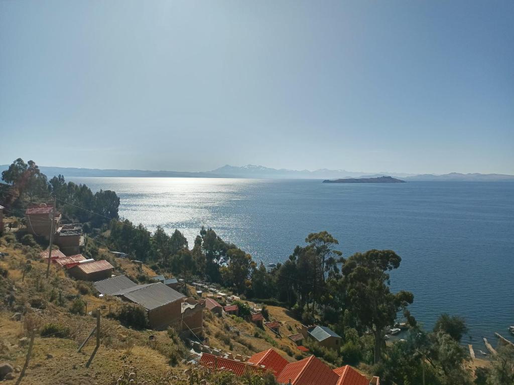 a town on a hill next to the water at Ecolodge El descanso in Comunidad Yumani