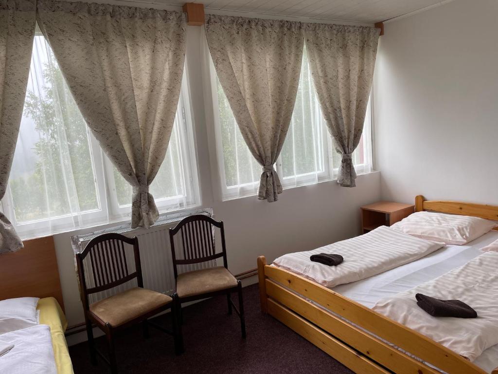 Postel nebo postele na pokoji v ubytování Penzion Na Srubech