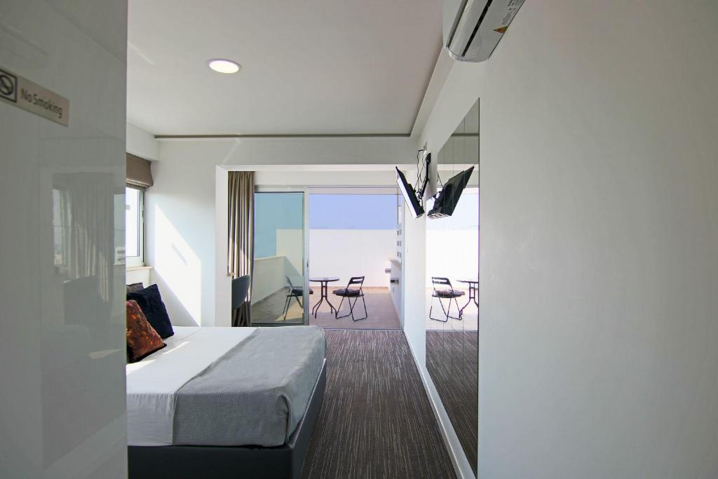 a bedroom with a bed and a balcony with a table at Phaedrus Living: Luxury Suite Nicosia 503 in Nicosia