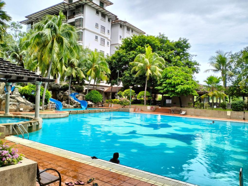 a swimming pool in front of a hotel at Homestay Melaka at Mahkota Hotel - unit 3093 - FREE Wifi & Parking in Melaka