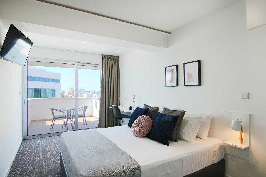a hotel room with a bed and a balcony at Phaedrus Living: Luxury Suite Nicosia 505 in Nicosia