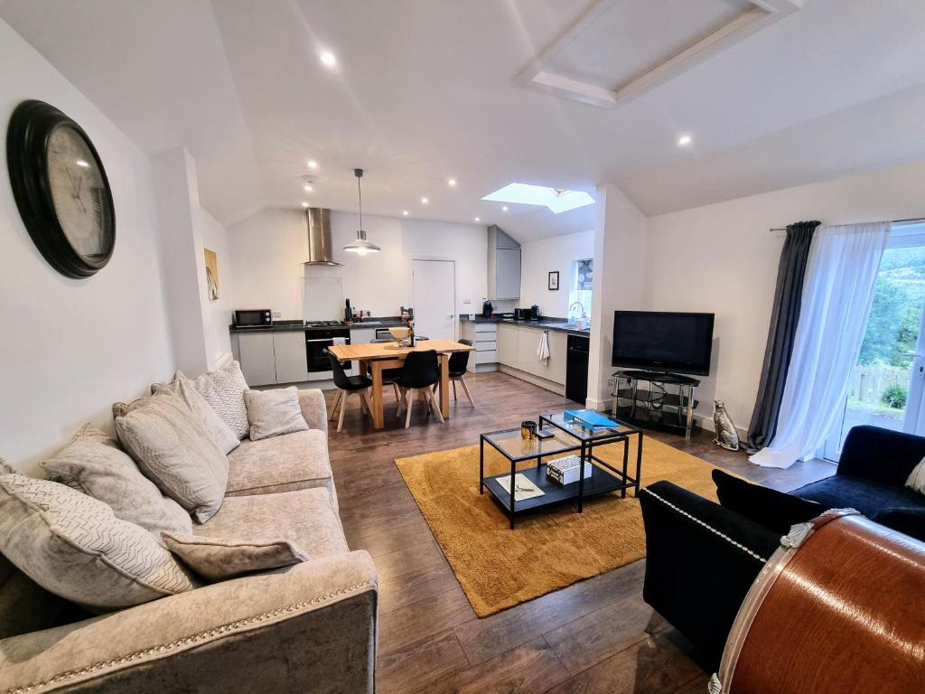 a living room with a couch and a table at No.1 Bloom Apartments, Bath in Bath