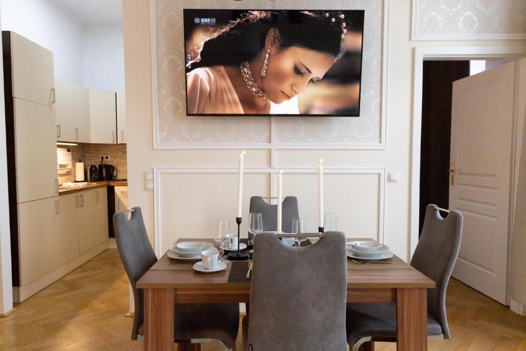 a dining room with a wooden table with chairs at SISSI beautifully designed apatment close to main train station in Vienna