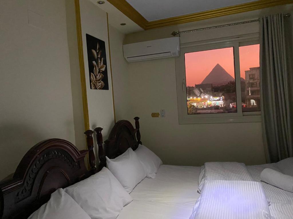 Voodi või voodid majutusasutuse Asma Pyramids View toas