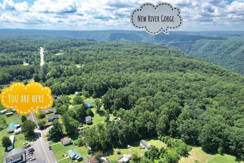 an aerial view of a forest with a new new house at THE GREEN HOUSE - New River Gorge National Park in Lansing