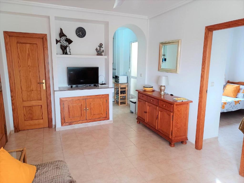 A television and/or entertainment centre at Molino Blanco Penthouse 15
