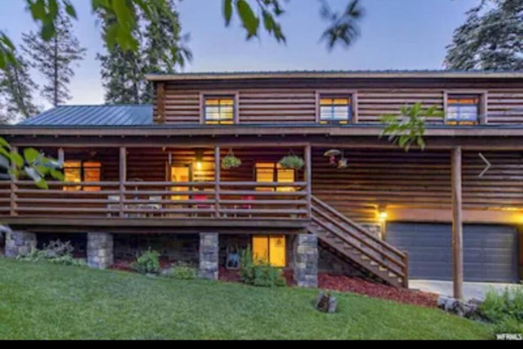 een groot houten huis met lichten aan in de tuin bij 4 Bedroom Cabin in Summit Park, close to Park City in Park City