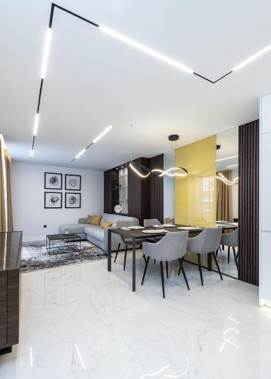 a dining room and living room with a table and chairs at Diamond Beach Sarafovo by KP - Luxury Collection, Apt 5 in Burgas