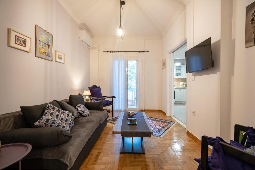 a living room with a couch and a coffee table at Metaxourgeio metro st. 2 bedrms 4 pers. apartment. in Athens