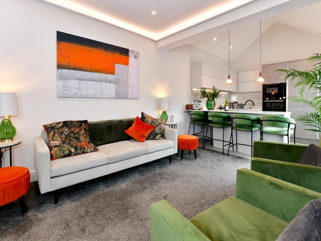 a living room with a couch and a kitchen at Pass the Keys Stunning 2 Bedroom Apartment in Heart of Pontcanna in Cardiff