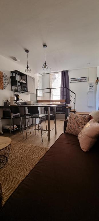 a living room with a couch and a table at Appartement chaleureux en Ardèche in Châteaubourg