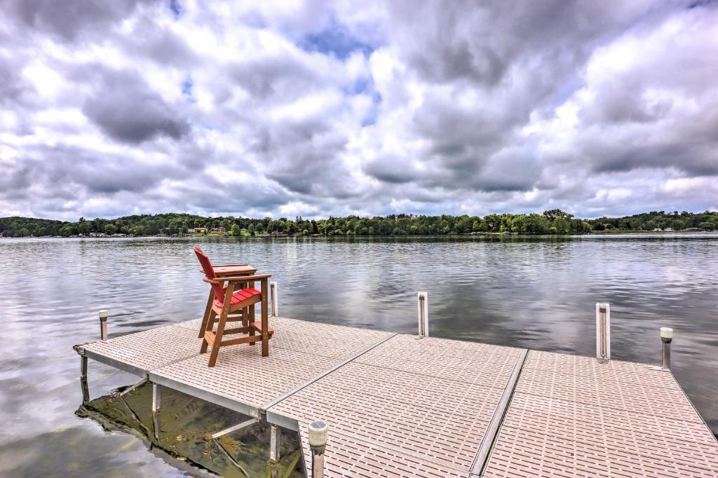 a chair sitting on a dock on a body of water at Cascade Lakefront Home Boat Dock, Fire Pit! in Cascade