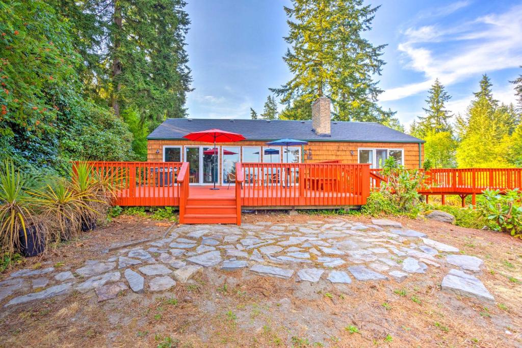 a small cabin with an orange fence and a patio at 26 Mi to Mount Rainier, Game Room Puyallup Oasis in Puyallup