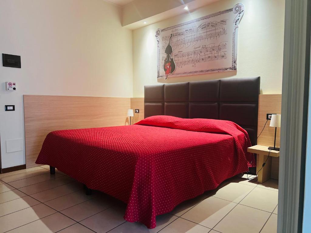 Postel nebo postele na pokoji v ubytování Albergo Visconti