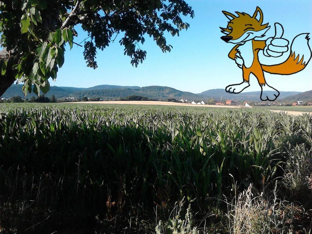 a cartoon fox jumping in a field of grass at Apartment 1 Langelsheim Harz in Langelsheim