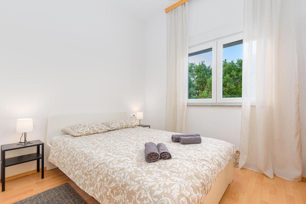 Postel nebo postele na pokoji v ubytování Apartmani Vita, Ližnjan - apartman 1