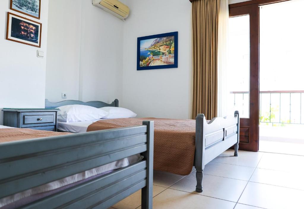 a bedroom with two beds and a window at Villa Moras in Paralia Katerinis