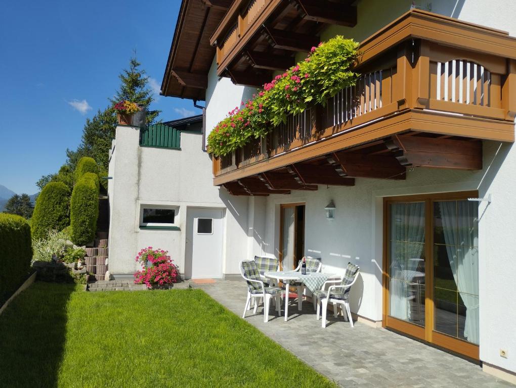 a patio with a table and chairs and a balcony at Apart Christina in Tarrenz