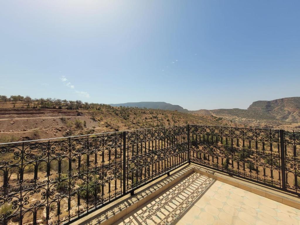 a balcony with a view of the mountains at Riad Heermans in Ouzoud