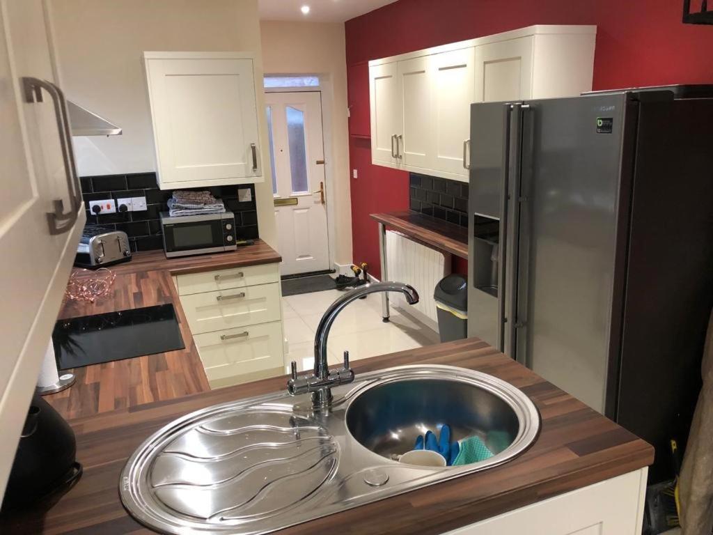 a kitchen with a sink and a refrigerator at The Little Hexthorpe house in Doncaster