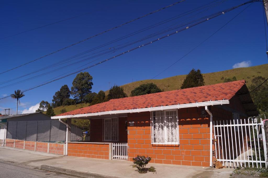 a small red brick house with a red roof at Casa Campestre la Guacamaya in San Félix