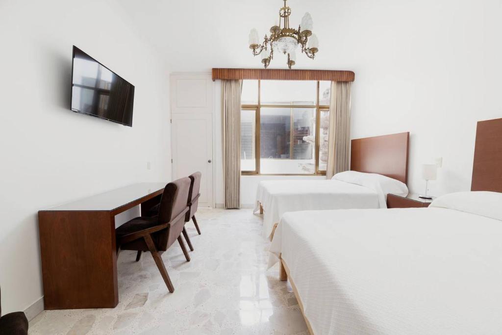 Postel nebo postele na pokoji v ubytování Violeta Hotel Boutique