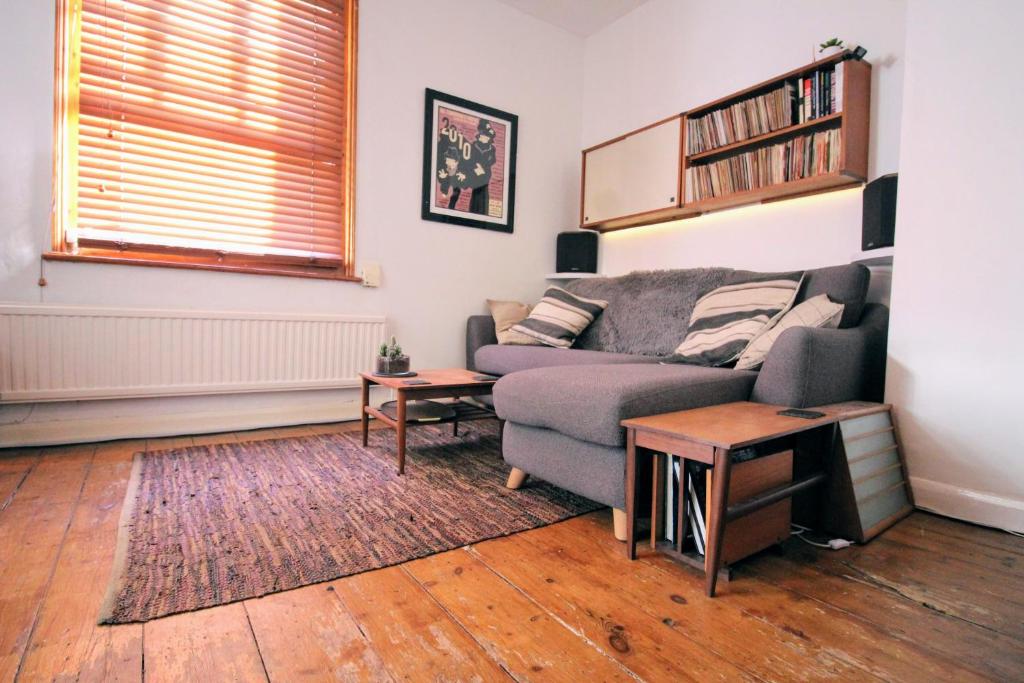 a living room with a couch and a table at Traditional Victorian 2 bed in cobbled street + mod cons - Full home in London