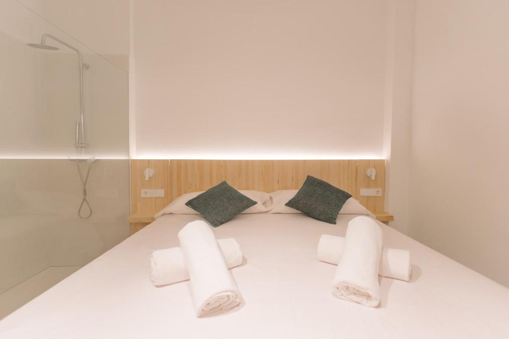 A bed or beds in a room at La Vila Hort by Seaward Suites