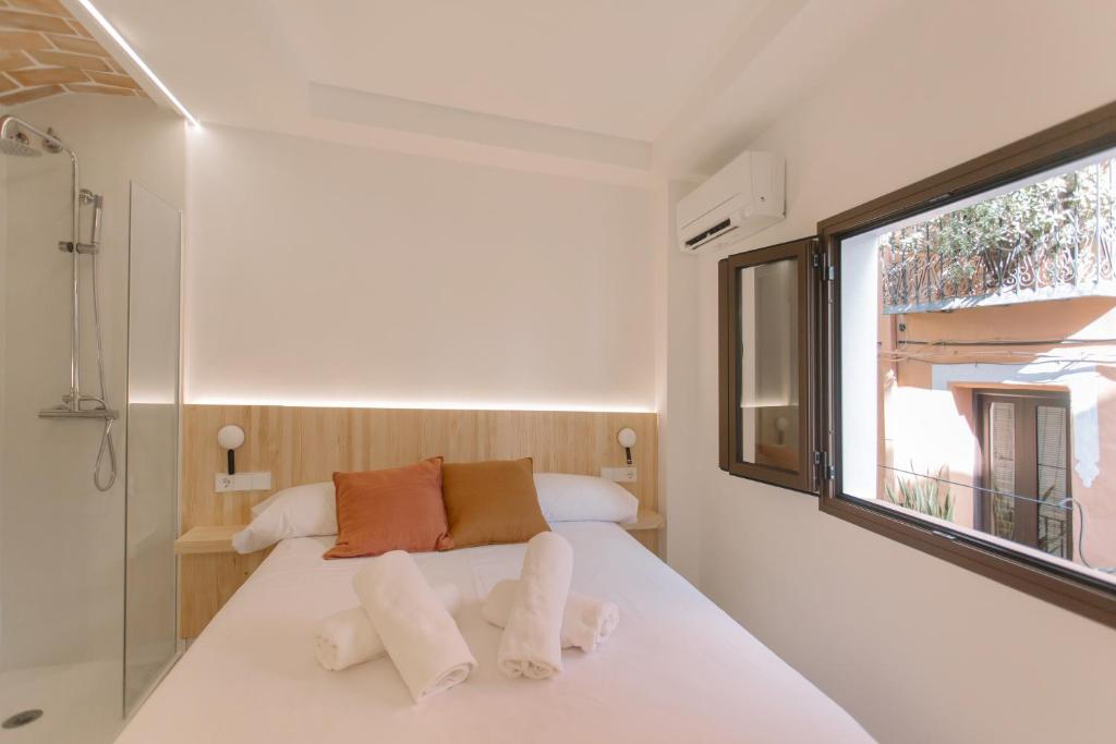 A bed or beds in a room at La Vila Hort by Seaward Suites