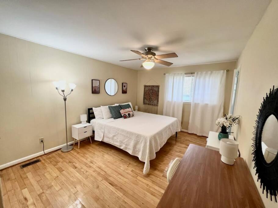 a bedroom with a bed and a ceiling fan at *Comfortable Townhome * King Beds * Long Term* in Cary