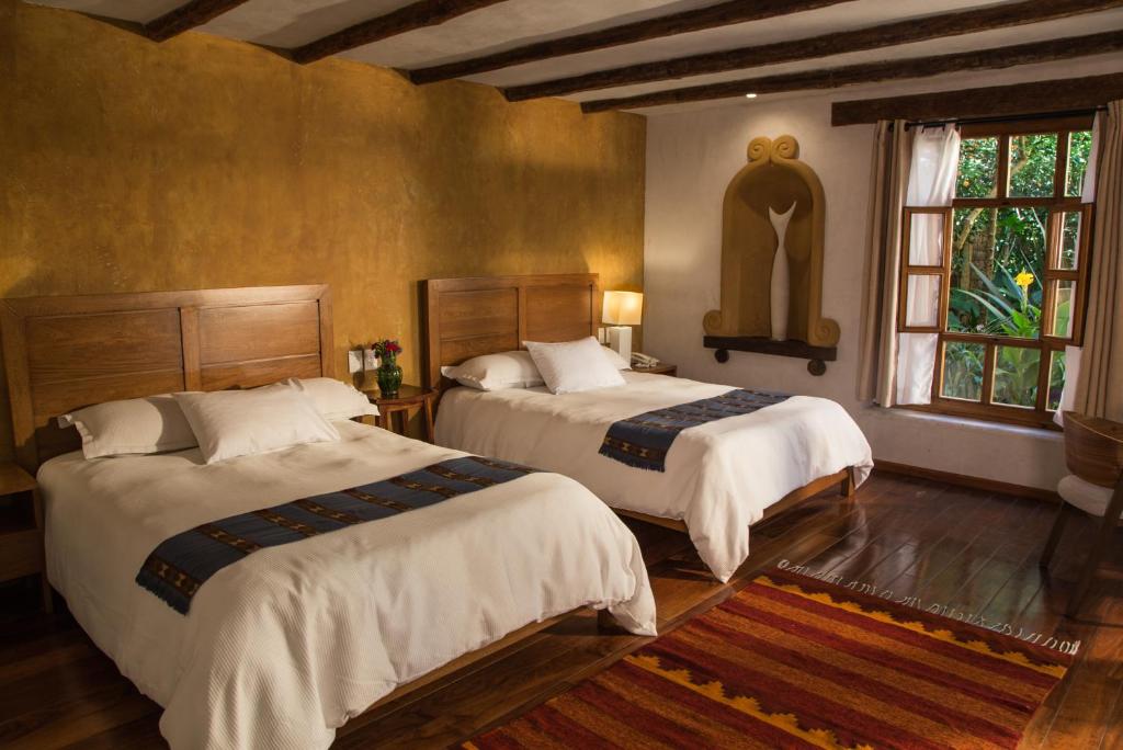 Postel nebo postele na pokoji v ubytování Guayaba Inn Boutique Hotel