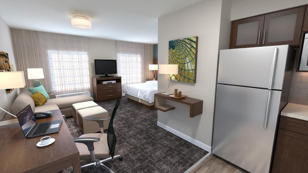 a hotel room with a kitchen and a living room at Staybridge Suites - Calgary Airport by IHG in Calgary