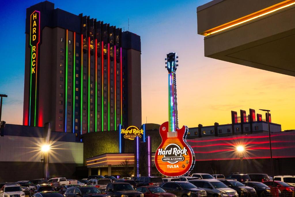 a guitar sign in a parking lot with cars parked at Hard Rock Hotel & Casino Tulsa in Tulsa