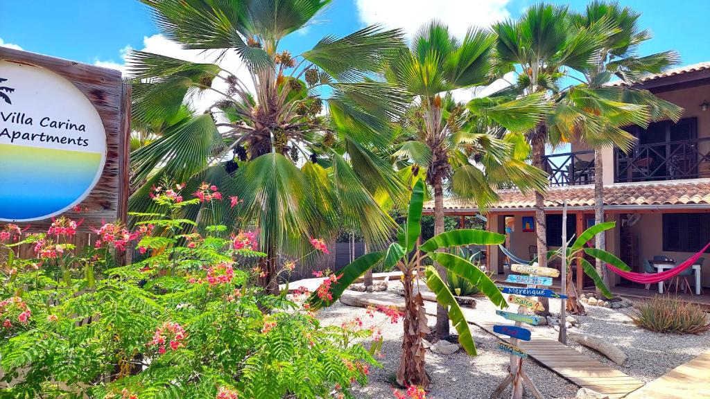 a resort with palm trees in front of a building at Villa Carina Apartments in Kralendijk