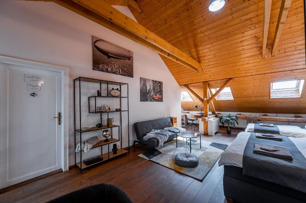 a living room with a couch and a wooden ceiling at Vintage Industrial City Apartments in Košice