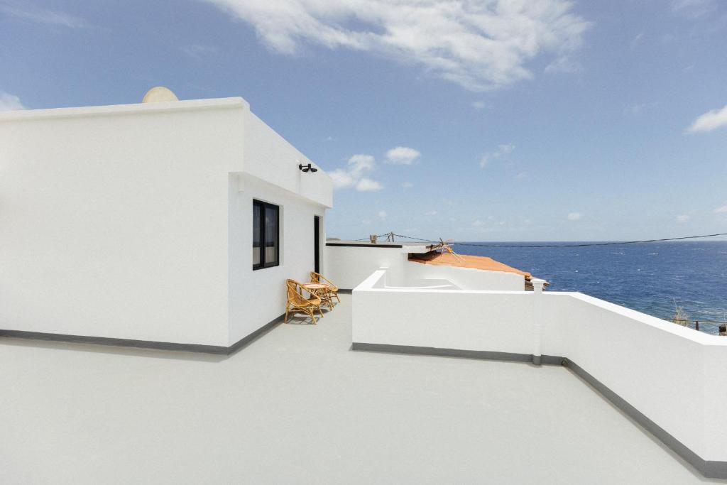 a white house with a view of the ocean at La Casa de La Caleta by Taller96 - El Hierro Island - in La Caleta