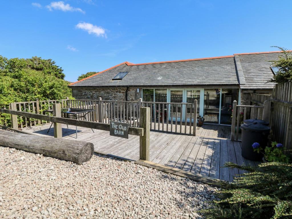 a wooden deck in front of a house at The Old Barn in Penzance