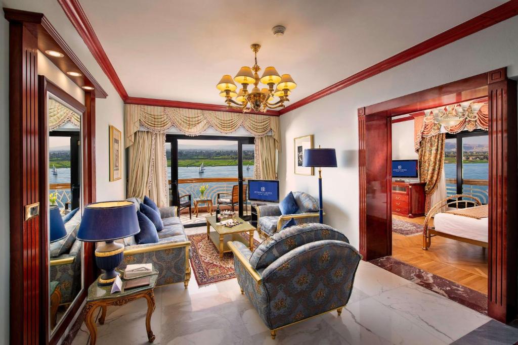 a living room filled with furniture and a chandelier at Sonesta St. George Hotel - Convention Center in Luxor