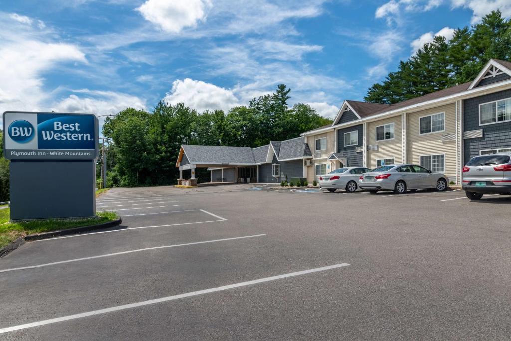 a best western sign in a parking lot in front of a building at Best Western Plymouth Inn-White Mountains in Campton