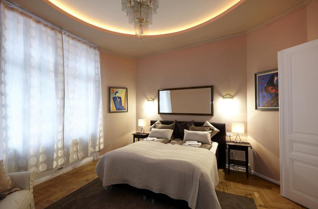 a bedroom with a bed and a large window at Urban Flats Vienna City Center in Vienna