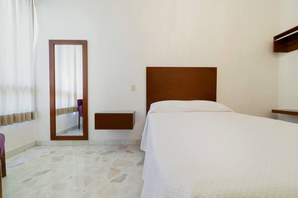 Postel nebo postele na pokoji v ubytování Violeta Hotel Boutique