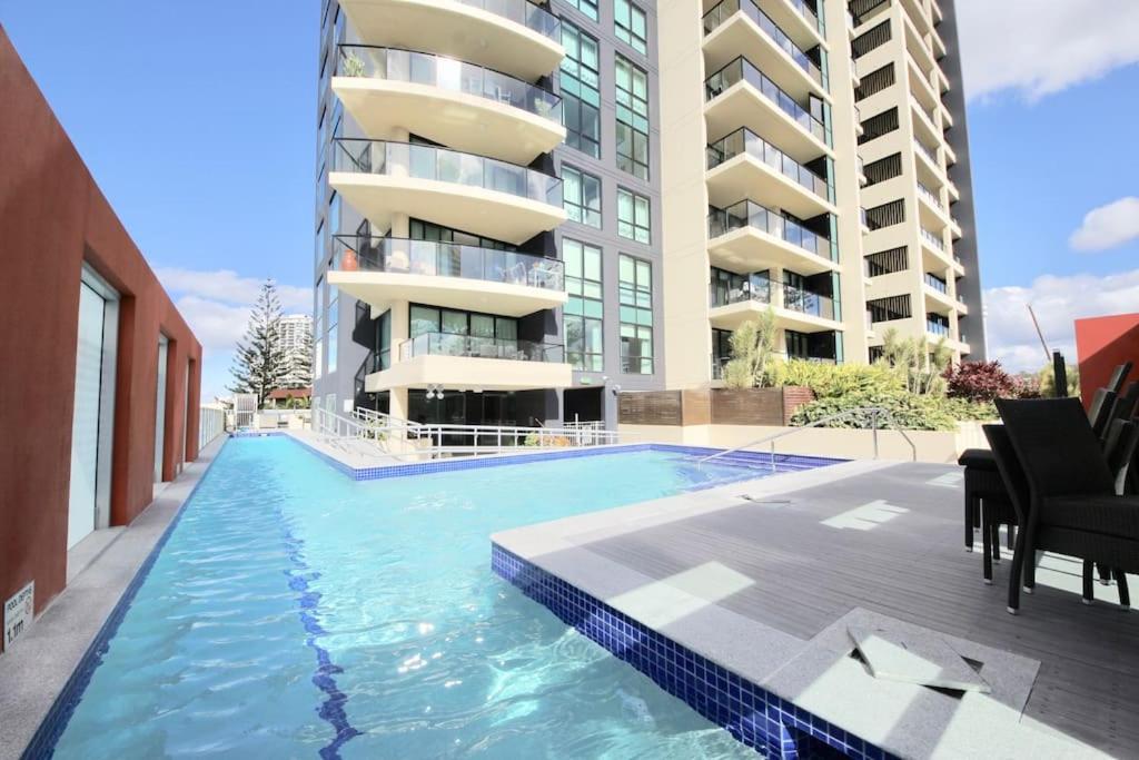 a swimming pool in front of a apartment building at BB on the Park 502 in Gold Coast