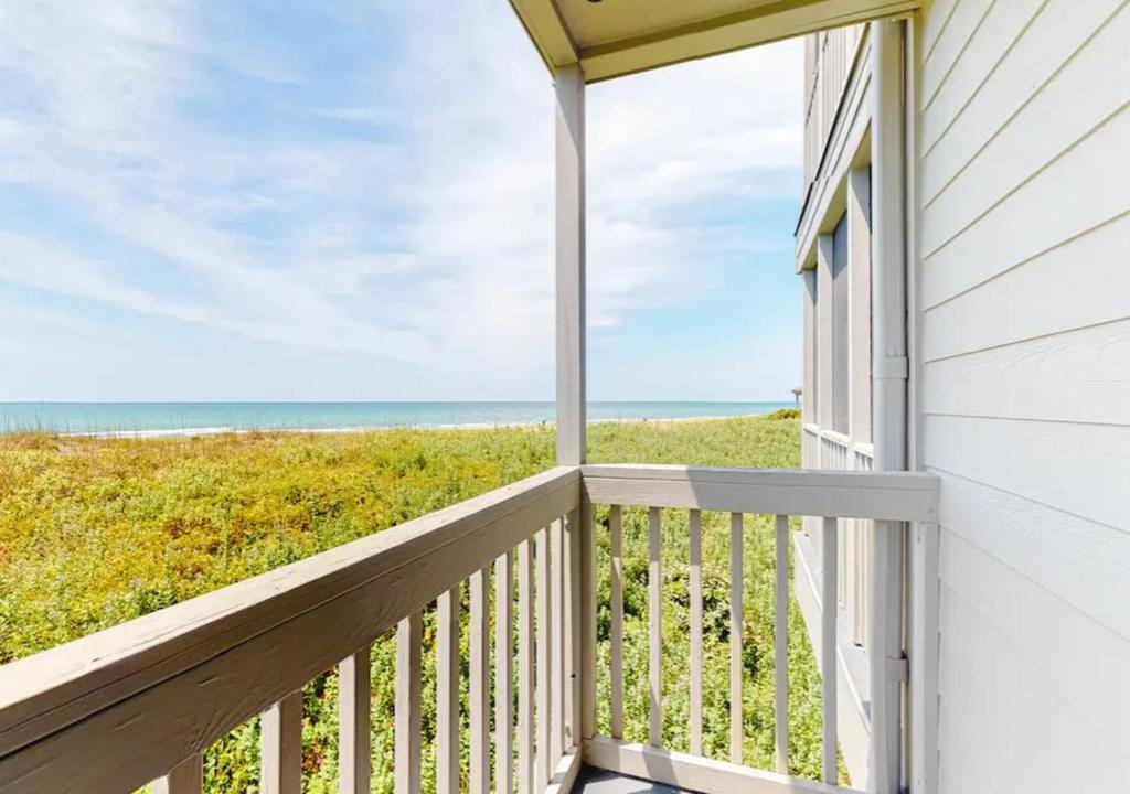 a balcony with a view of the beach at Dunescape Villas by TO in Atlantic Beach