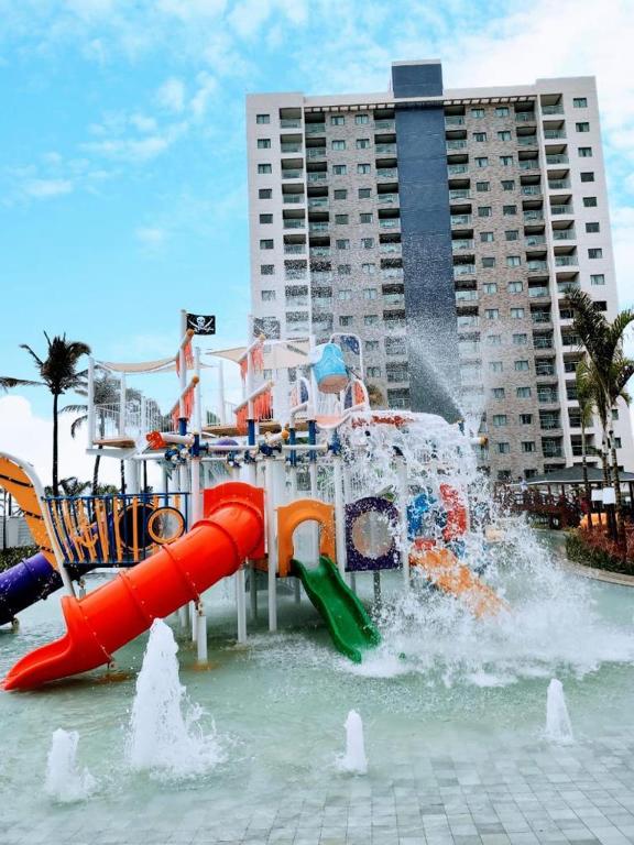 a water park with a water slide in the water at Exclusive Resort in Salinópolis