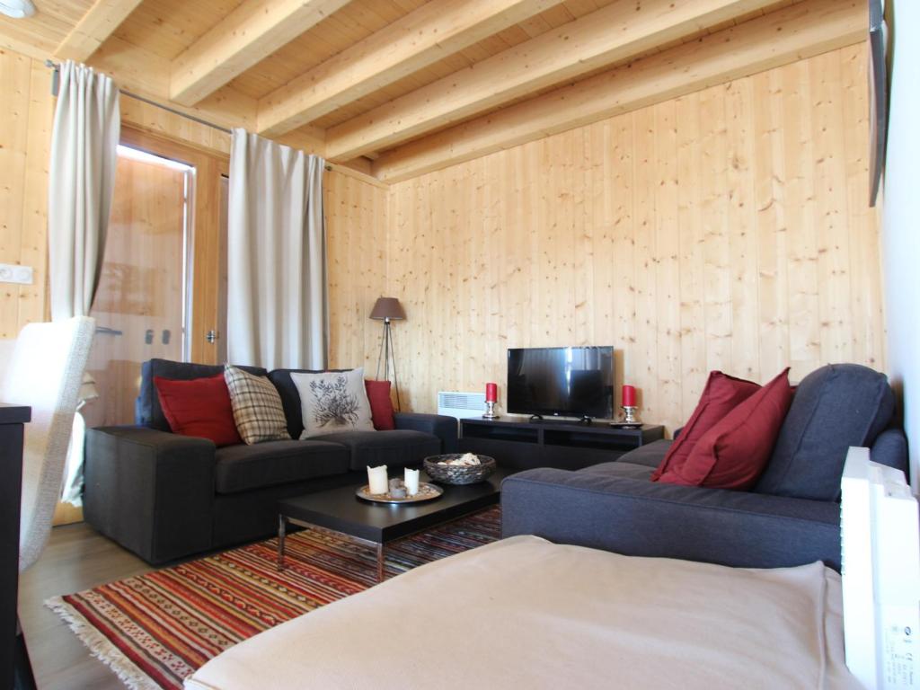 a living room with two couches and a tv at Chalet Chamrousse, 5 pièces, 8 personnes - FR-1-549-105 in Chamrousse