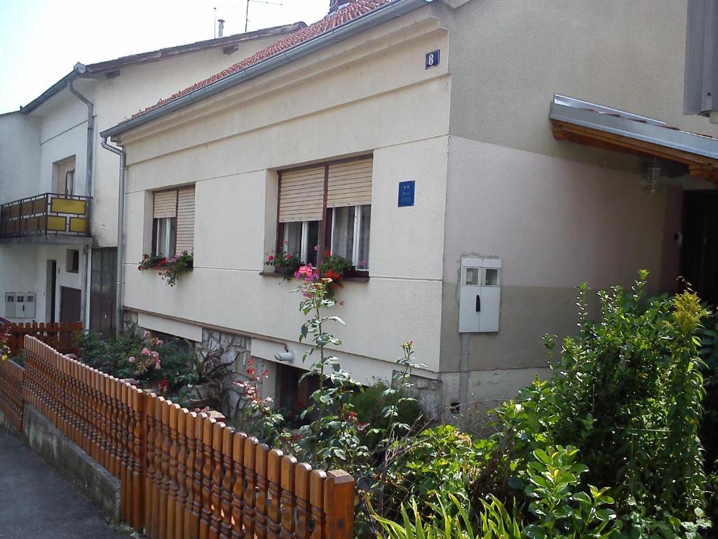 a building with flower boxes on the windows and a fence at Apartments with WiFi Daruvar, Bjelovarska - 17093 in Daruvar