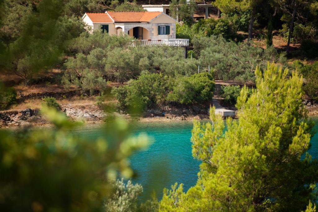 a house on a hill next to a river at Seaside holiday house Cove Gabrica, Korcula - 17195 in Vela Luka