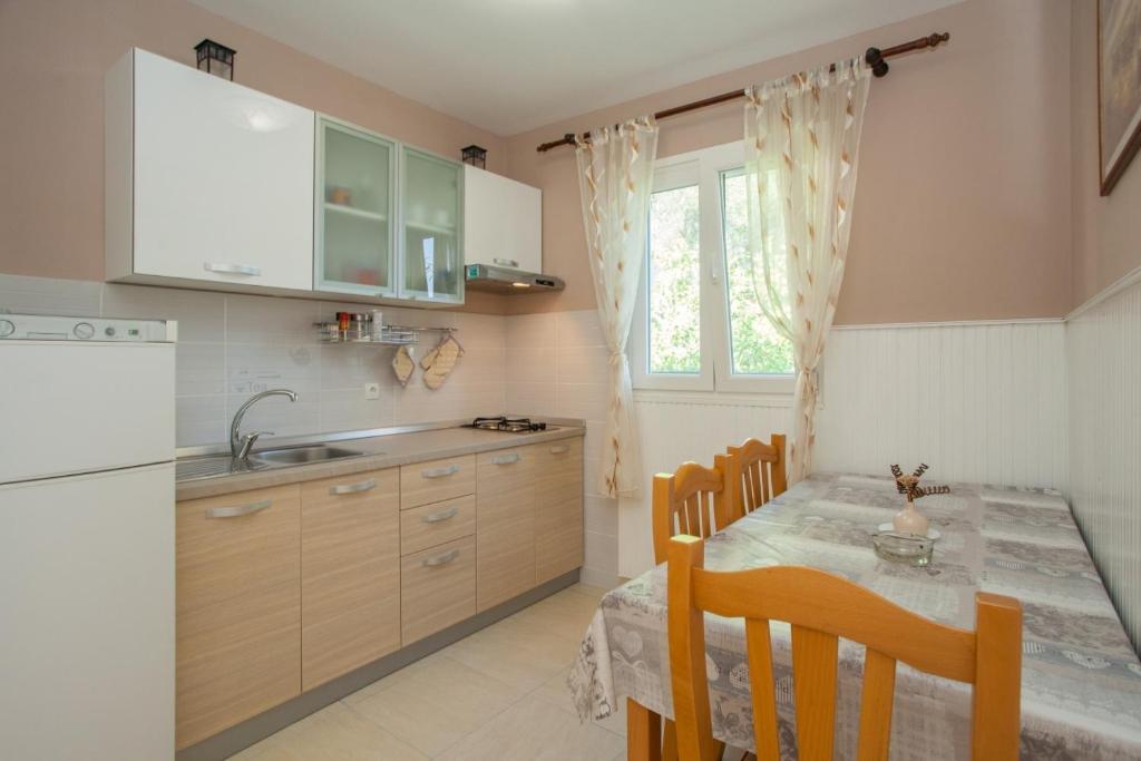a kitchen with a table with chairs and a sink at Seaside holiday house Cove Gabrica, Korcula - 17195 in Vela Luka