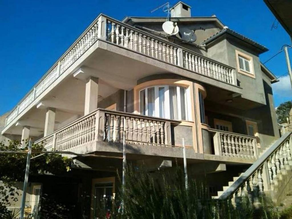 a large house with a balcony on the side of it at Apartments by the sea Prizna, Senj - 17309 in Senj