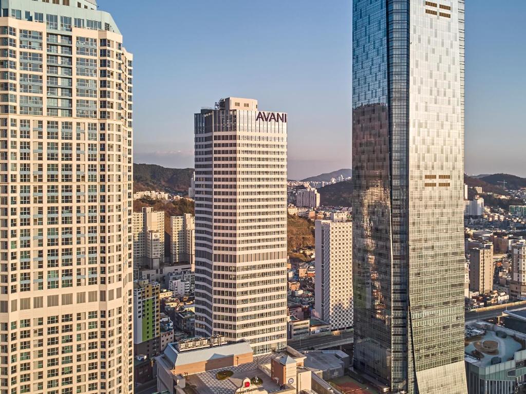 a view of two tall buildings in a city at Avani Central Busan in Busan